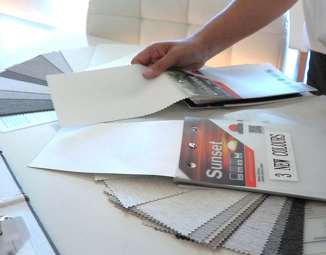 A specialist explains curtain color options in a free in-home consultation